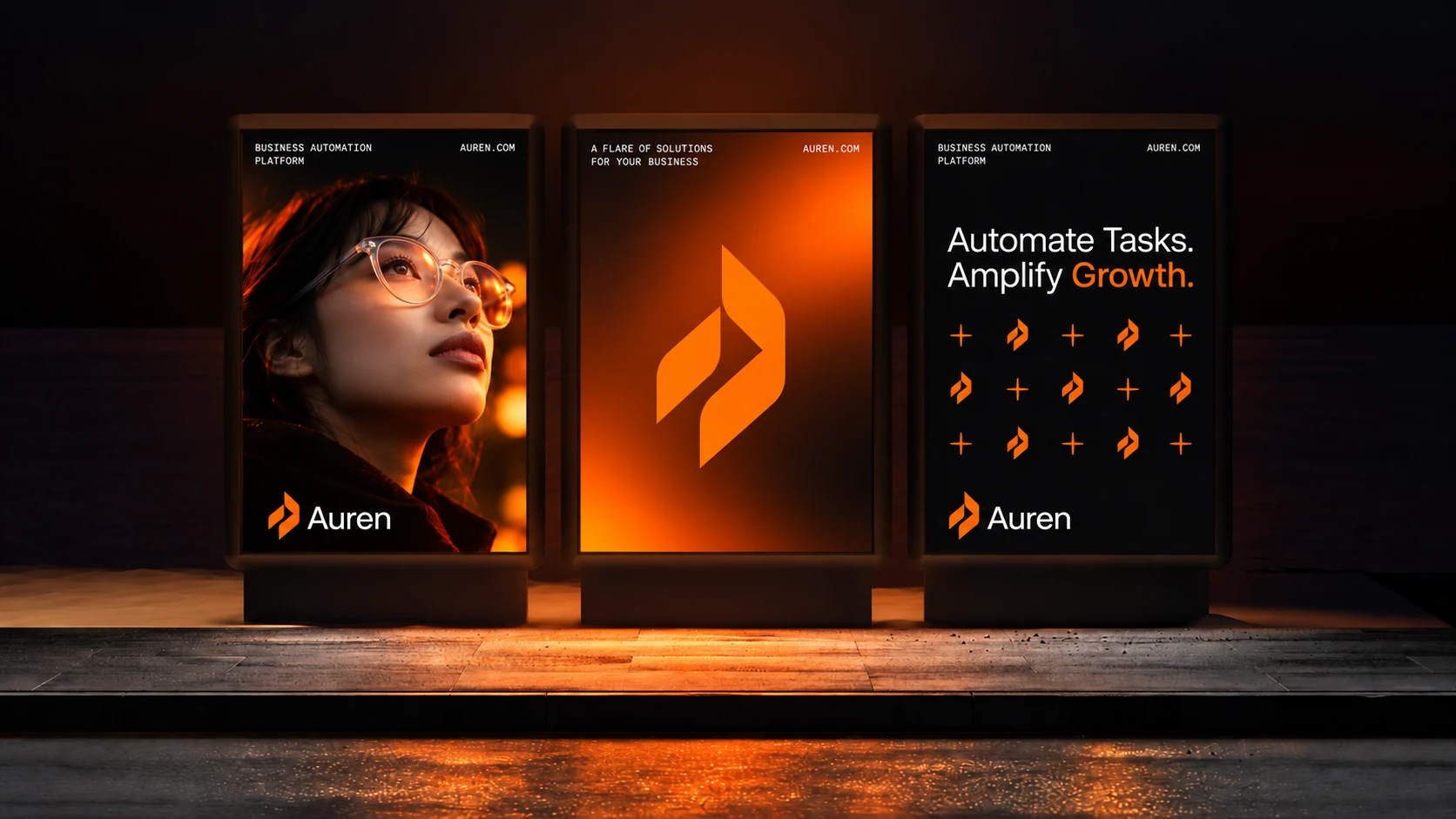Three illuminated Auren campaign posters combining a portrait, the orange symbol and the message Automate Tasks, Amplify Growth.