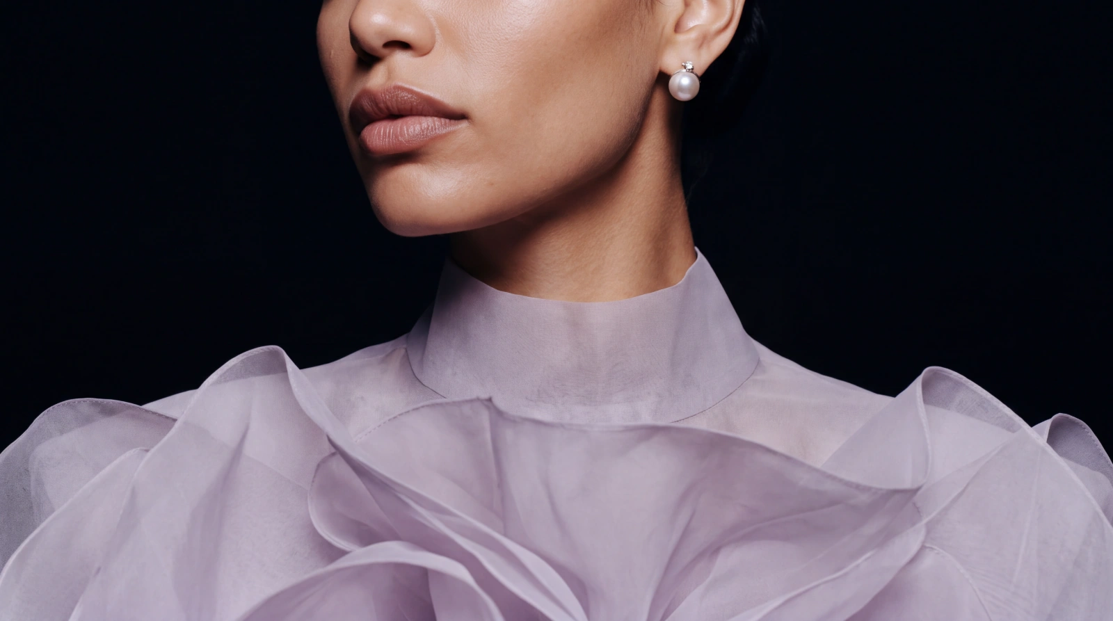 Close-up of the high organza collar and a pearl earring